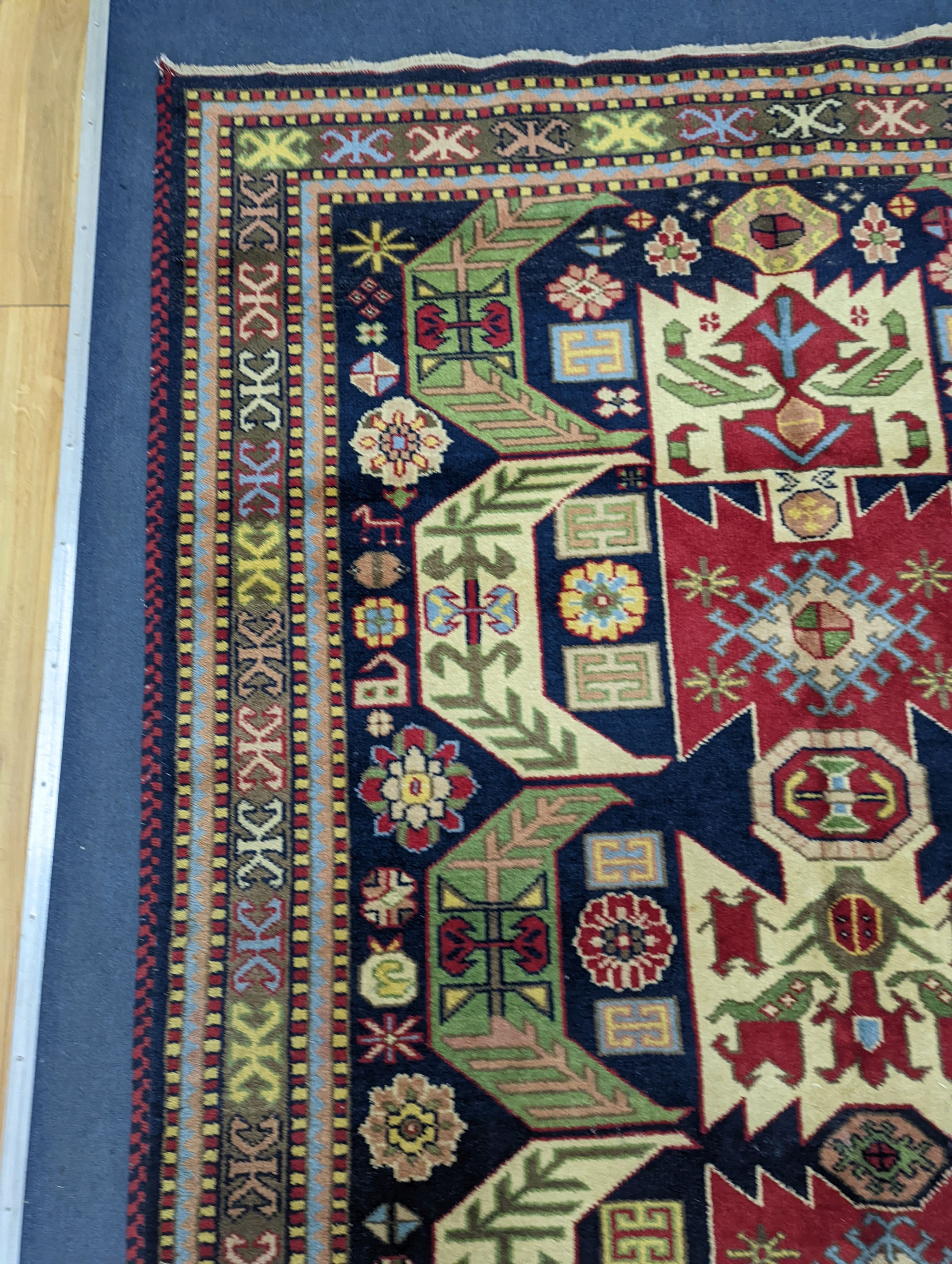 A Caucasian blue ground rug, 240 x 176cm